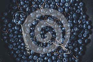 Blueberries on vintage wooden black background top view, healthy food on dark table mockup, berry for smoothie with vintage metal