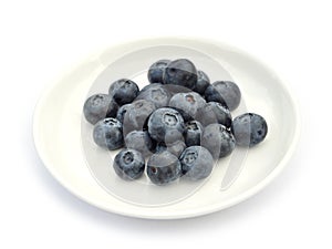 Blueberries on white dish
