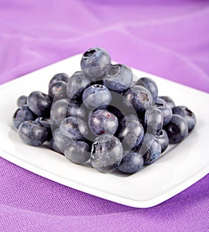 Blueberries on white plate - close up
