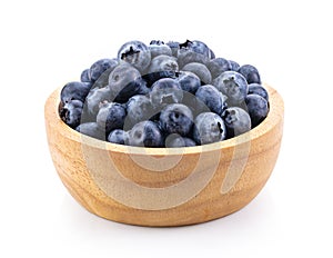 Blueberries in wood bowl  isolated on white background