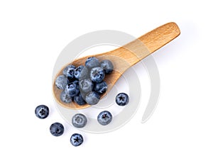 Blueberries in wood spoon  isolated on white background.