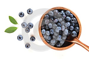 Blueberries in a wooden bowl with a spoon