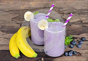 Blueberry and banana smoothies purple colorful fruit juice milkshake blend beverage healthy high protein the taste yummy.