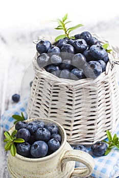 Blueberry basket and jug on white wooden table