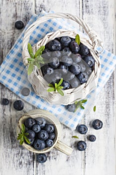 Blueberry basket and jug on white wooden table