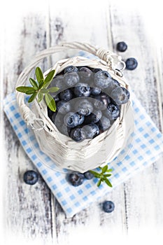 Blueberry basket on white wooden table