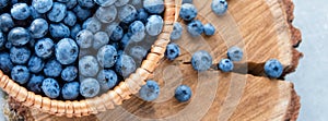 Blueberry in basket on wooden table background. Ripe and juicy fresh picked blueberries closeup, top view