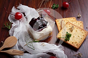 Blueberry cheese pie with cherry and Biscuits on wooden table