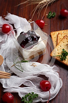 Blueberry cheese pie with cherry and Biscuits on wooden table