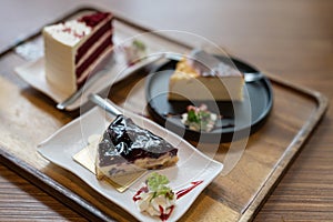 blueberry cheesecake with blur red velvet on wooden table