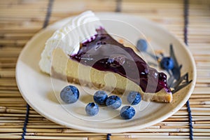 Blueberry cheesecake on the wooden background with blueberries
