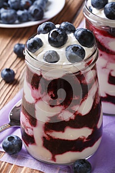 Blueberry cream in glass jar closeup vertical