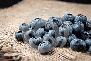 Blueberry on dark wooden background.