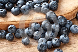 Blueberry. Fresh blueberries on a wooden surface close-up. Sprinkle blueberries. Scattered fresh blueberries. Organic food on a