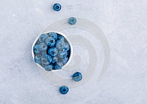 Blueberry. Fresh ripe organic blueberries in bowl on gray stone background