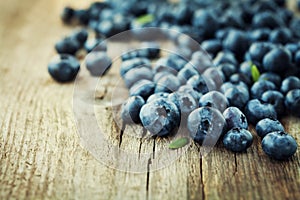 Blueberry, great bilberry or bog whortleberry on wooden board