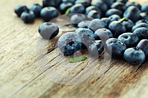 Blueberry, great bilberry or bog whortleberry on wooden board