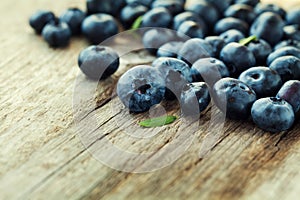 Blueberry, great bilberry or bog whortleberry on wooden board photo