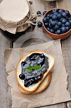 Blueberry jam on bread on wooden table