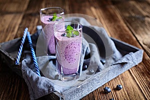 Blueberry milkshake in glass jars