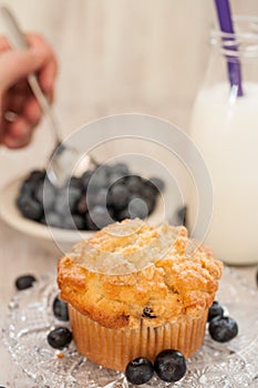 Blueberry Muffin Breakfast With Hand Spooning Blueberries