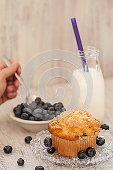 Blueberry Muffin Breakfast With Milk And Hand Spooning Blueberries