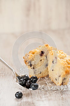 Blueberry Muffin on Plate with Spoonful of Blueberries