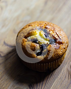Blueberry muffin on rustic wooden background