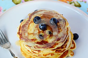 Blueberry pancakes for breakfast with maple syrup