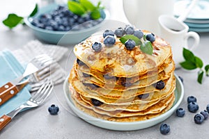 Blueberry pancakes with butter, maple syrup and fresh berries. American breakfast