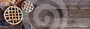 Blueberry pie table scene against a rustic wood banner background