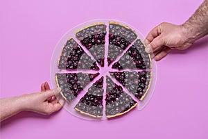 Blueberry pie top view  on purple background. Hands grabbing slices of pie