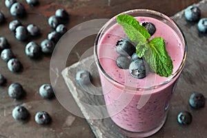 Blueberry smoothie with berries and mint, downward view on slate