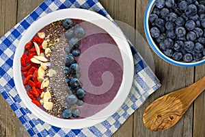 Blueberry smoothie bowl overhead table scene