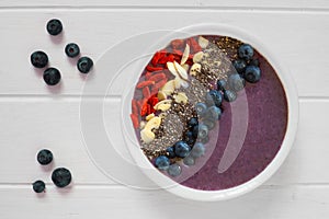 Blueberry smoothie bowl on white wood