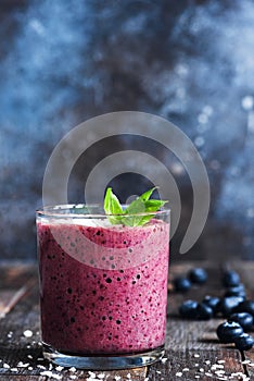 Blueberry smoothie decorated with basil leaf