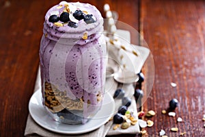 Blueberry smoothie with fruits and granola