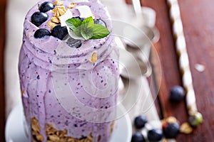 Blueberry smoothie with fruits and granola