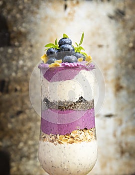 Blueberry smoothies with chia seeds in glass with berries and mint