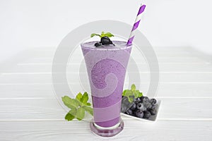 Blueberry smoothies fruit juices and blueberries on a white wooden backgroun. Drink in the morning for good health.