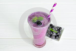 Blueberry smoothies, fruit juices and blueberries on a white wooden background. Drink in the morning for good health.