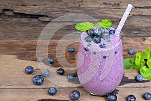 Blueberry smoothies juice beverage healthy the taste yummy In glass drink episode morning on wooden background.