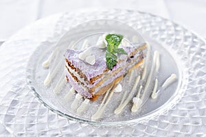 Blueberry sponge cake decorated with meringue and mint leaves. Breakfast in the cafe, morning coffee. on wooden table