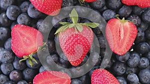 Blueberry and Strawberry, rotating backdrop. close-up. Vegan food, diet.