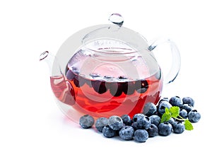 Blueberry tea in glass teapot isolated on white