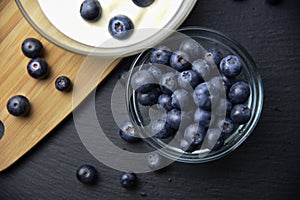 Blueberry yogurt in glass bowl on wooden table