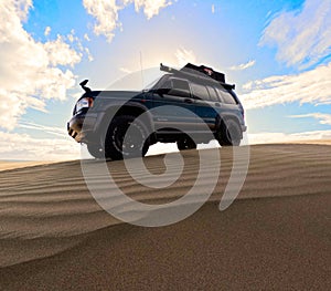 Blueish big horn on sand dune , big tyers, camping rigged