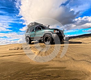 Blueish big horn on sand dune , big tyers, camping rigged