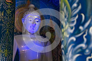 Blueish Buddha Statue inside the Blue Temple & x28;Rong Sua Ten temple& x29; in Chiang Rai, Thailand photo