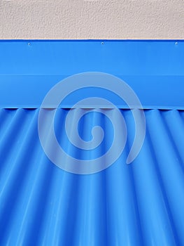 Blueish metallic corrugated sheet roof texture. Deep blue profiled sheet panel. Corrugated Metal Roof Exterior Close up